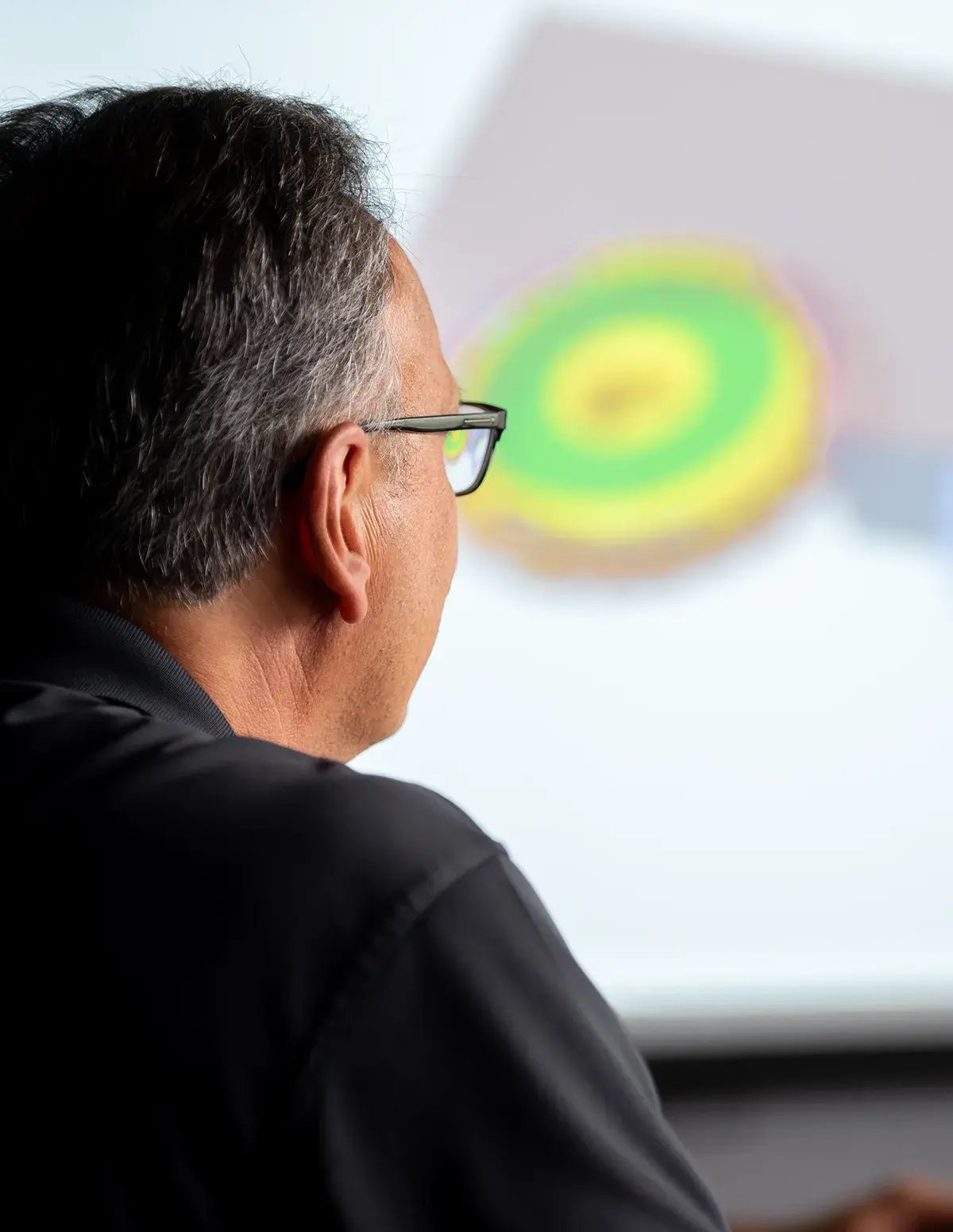 engineer looking at part on screen