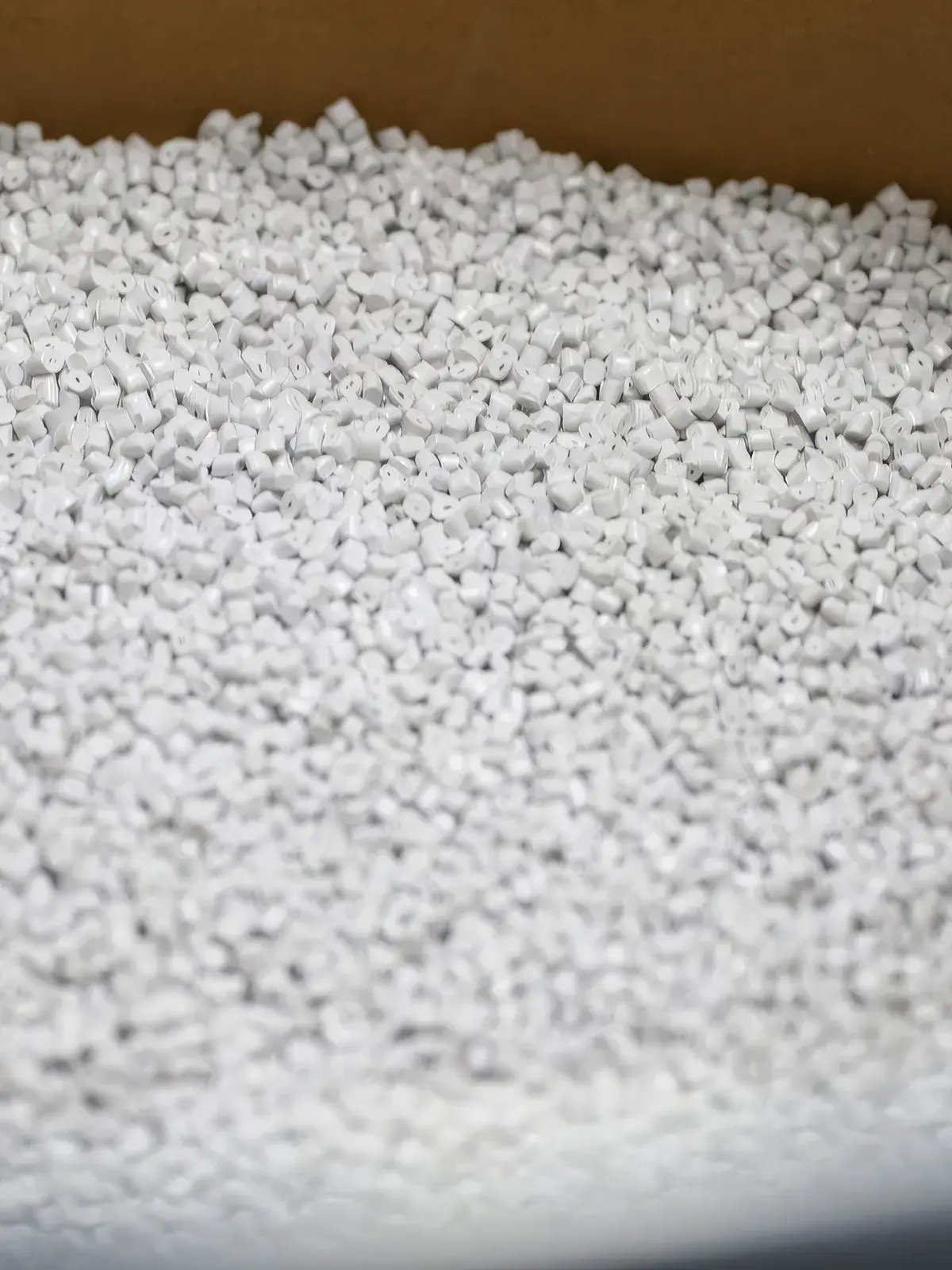 white plastic pellets in container