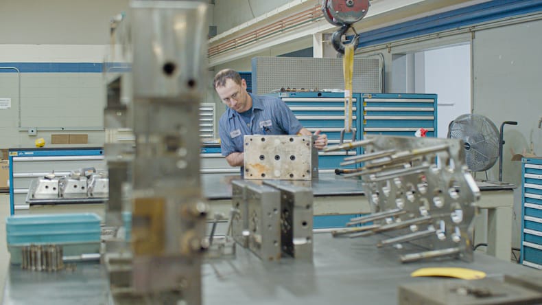 Injection molding tooling being worked on by a Kaysun employee