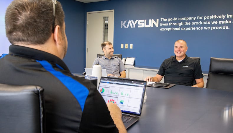 kaysun-team-in-meeting-with-data